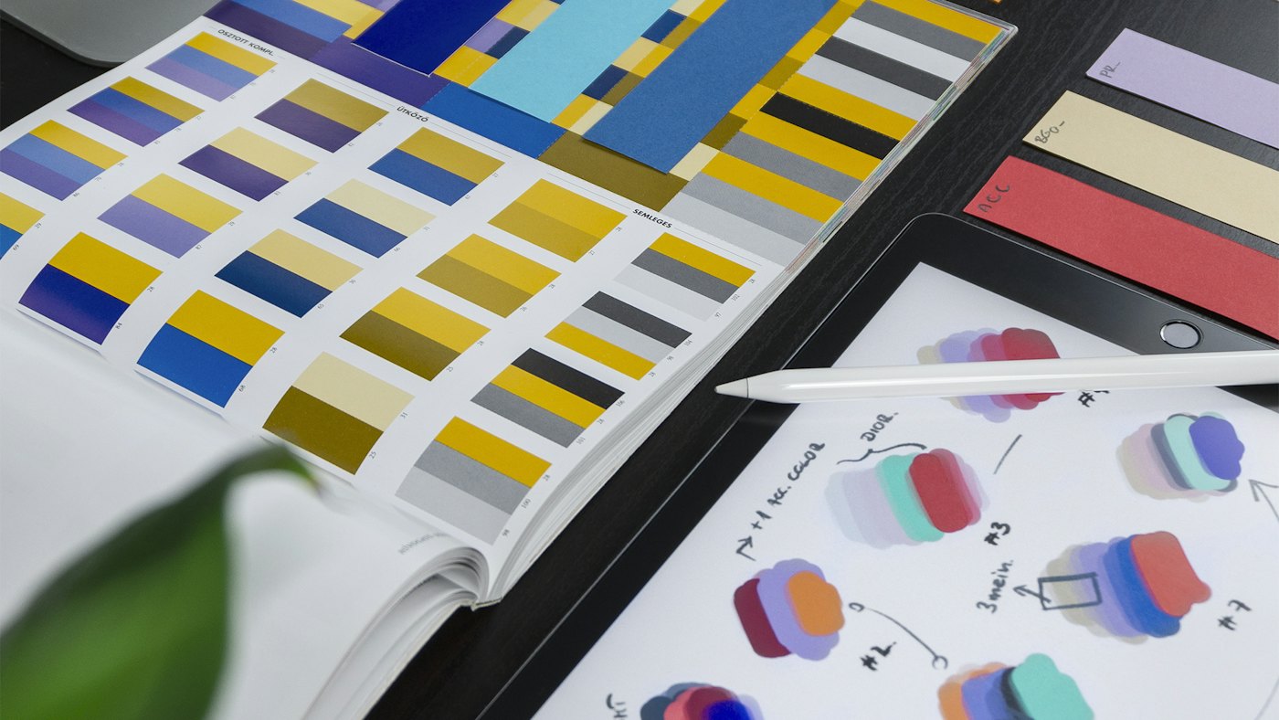 Designer sketching brand identity concepts and colour palettes for a startup