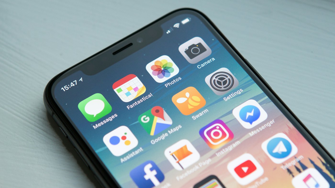 Smartphone and laptop showing the same app on mobile and web