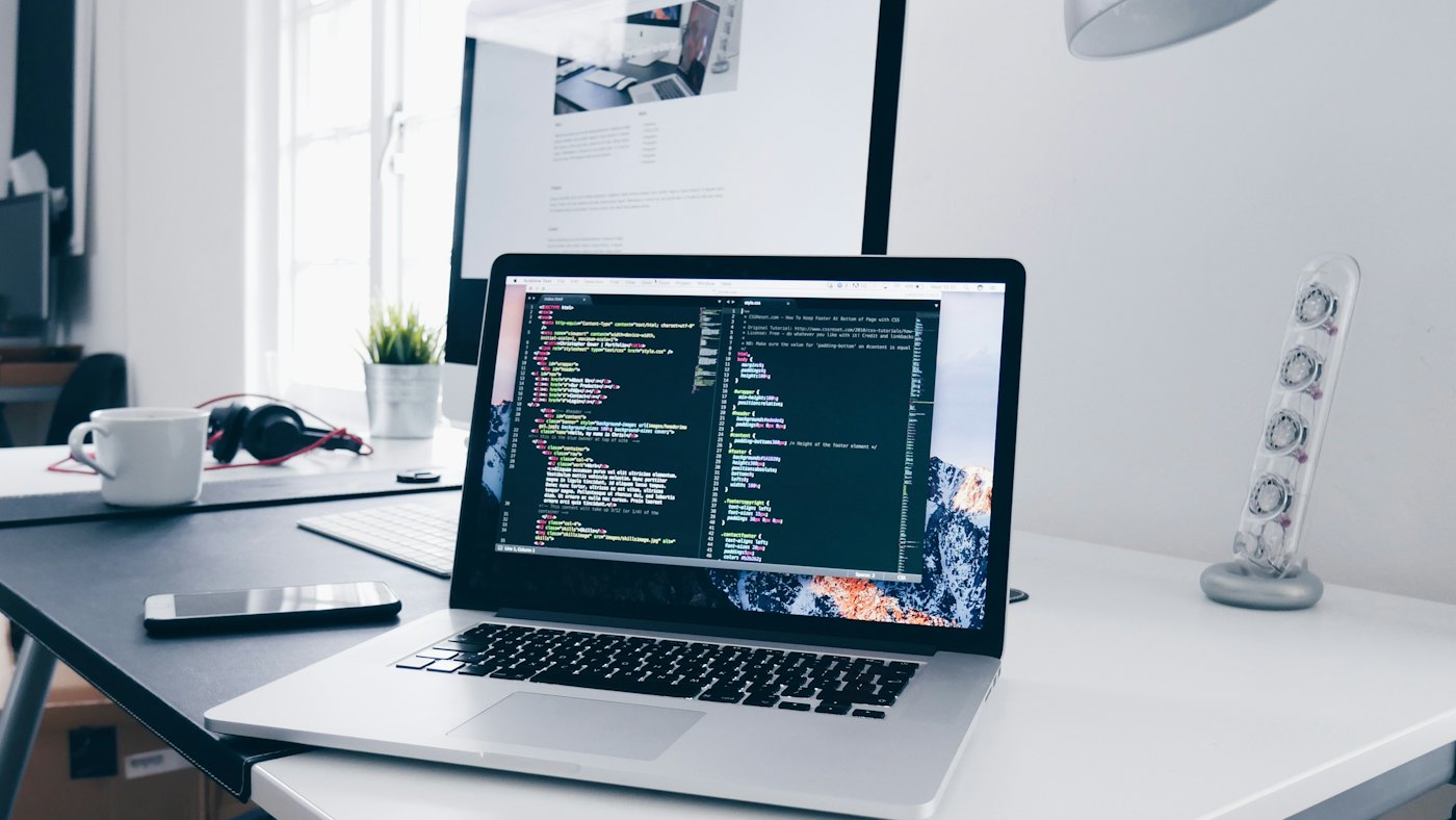 Laptop showing website code during final pre-launch checks